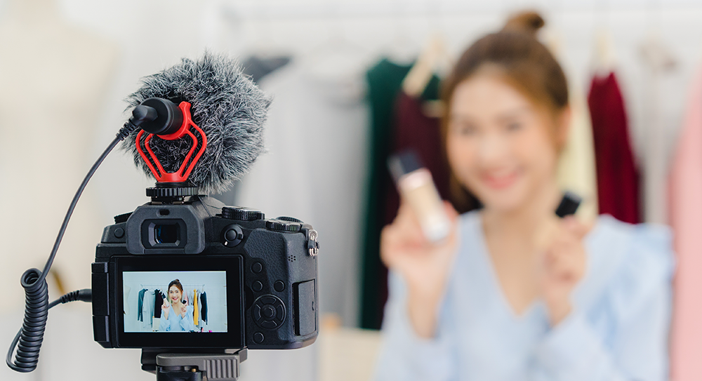 beauty blogger present beauty cosmetics sitting recording video camera